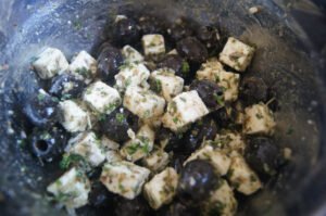 Mediterranean feta and olive appetizer with herbs and olive oil