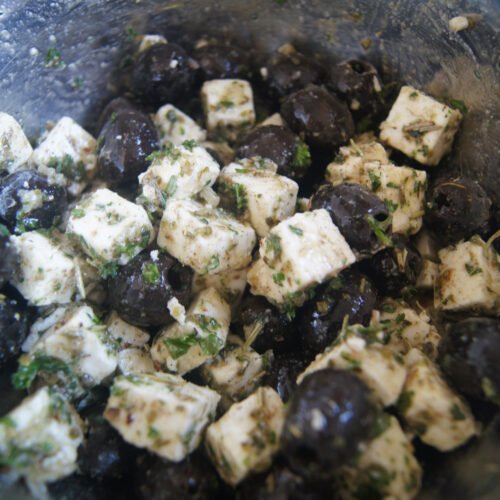 Mediterranean feta and olive appetizer with herbs and olive oil