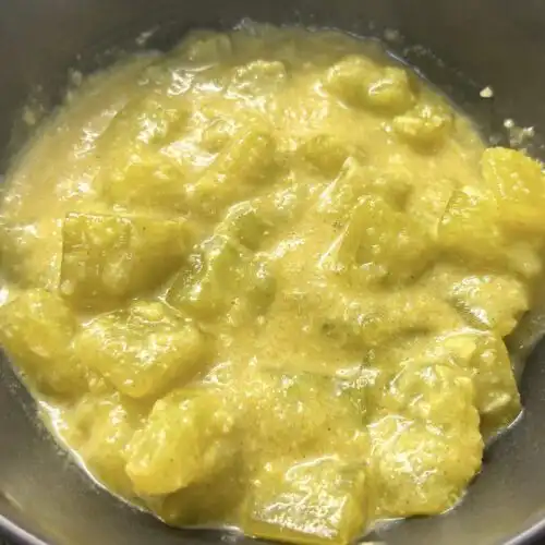 Sinhala cucumber curry with a creamy coconut mustard sauce and fragrant spices