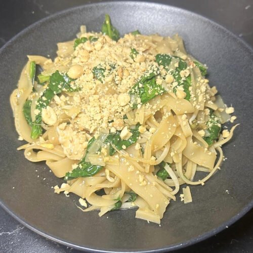 Easy chicken Pad Thai with rice noodles, tofu, peanuts, and fresh vegetables