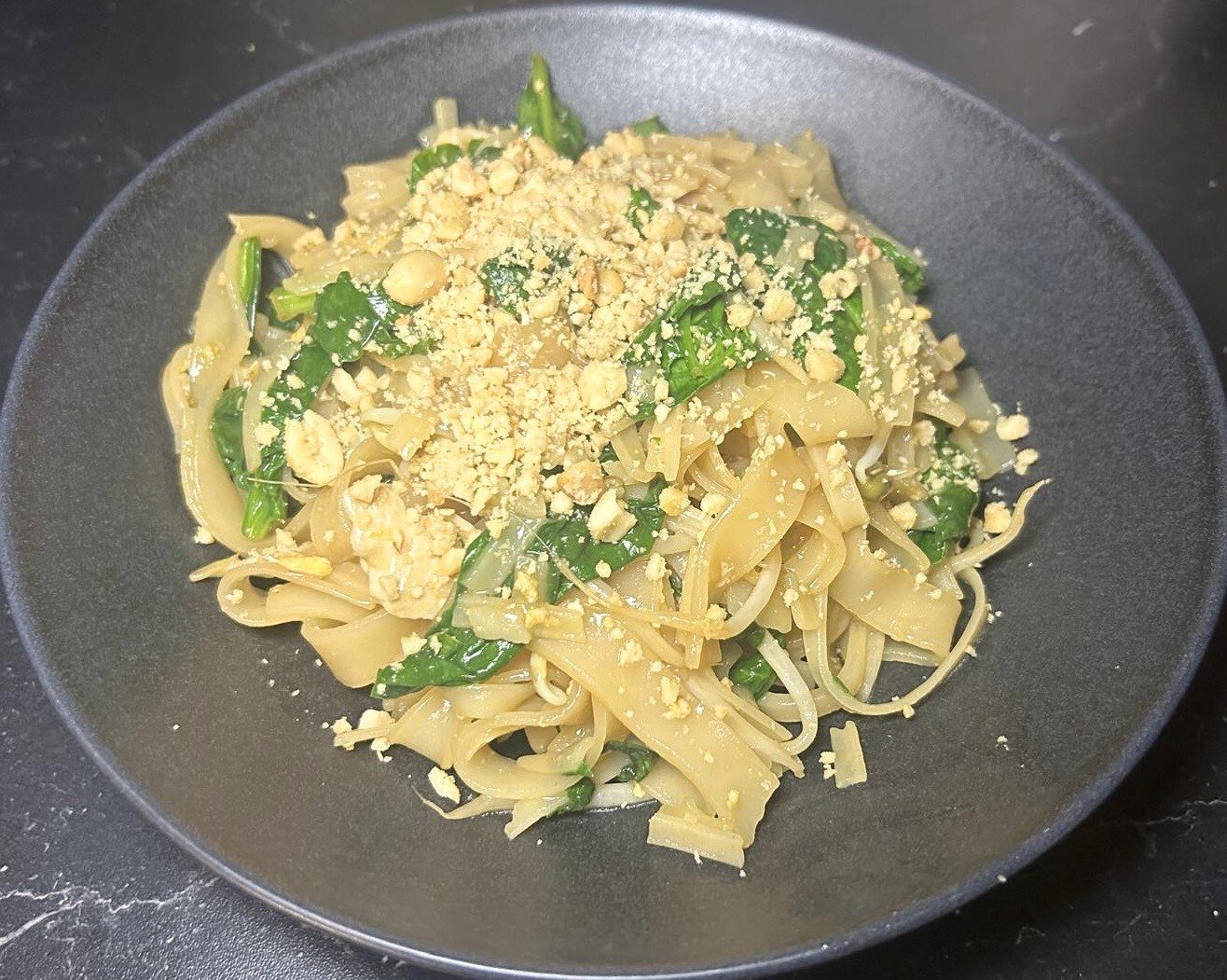 Easy chicken Pad Thai with rice noodles, tofu, peanuts, and fresh vegetables