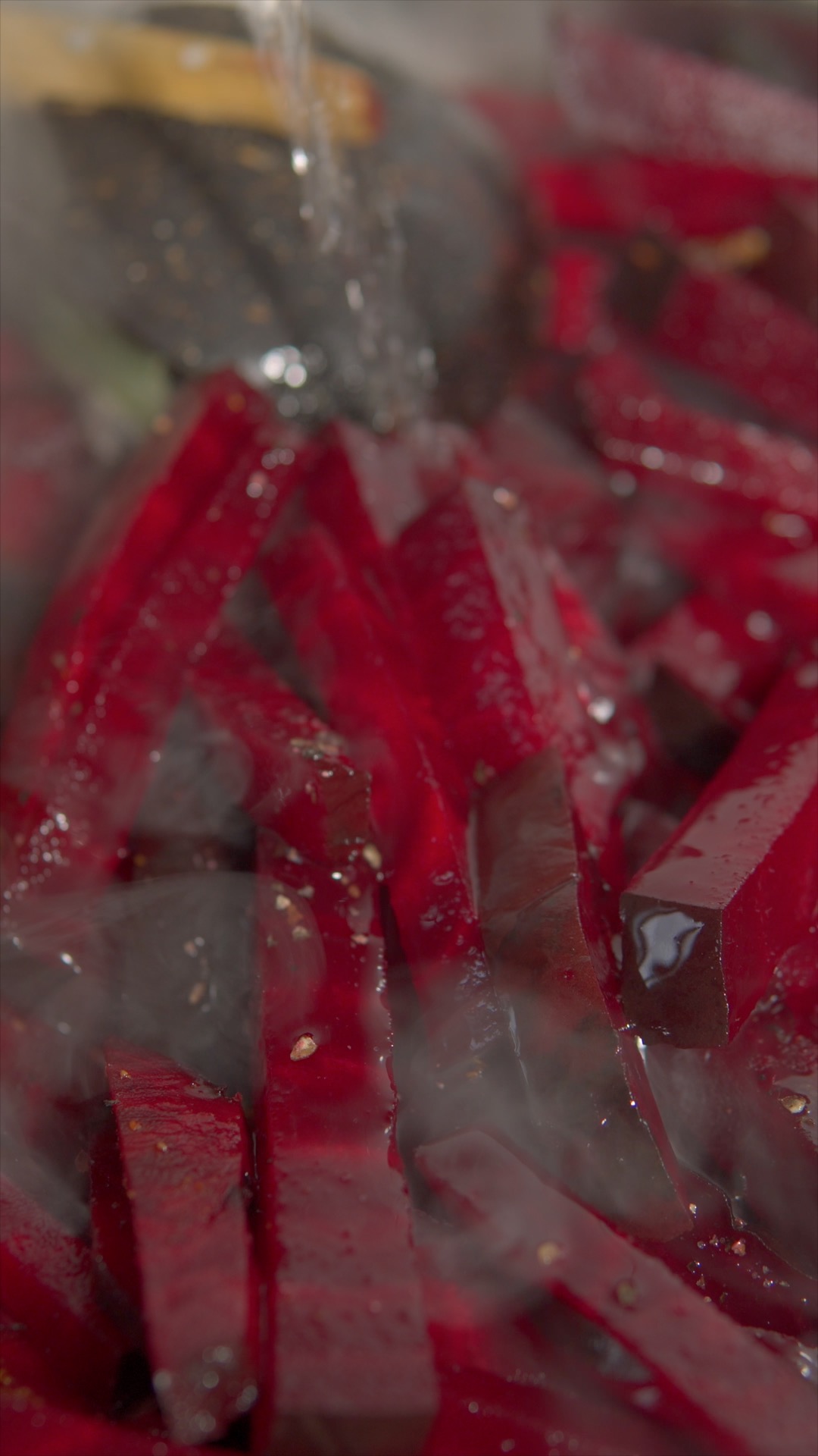 Adding a splash of water to simmer the beetroot curry